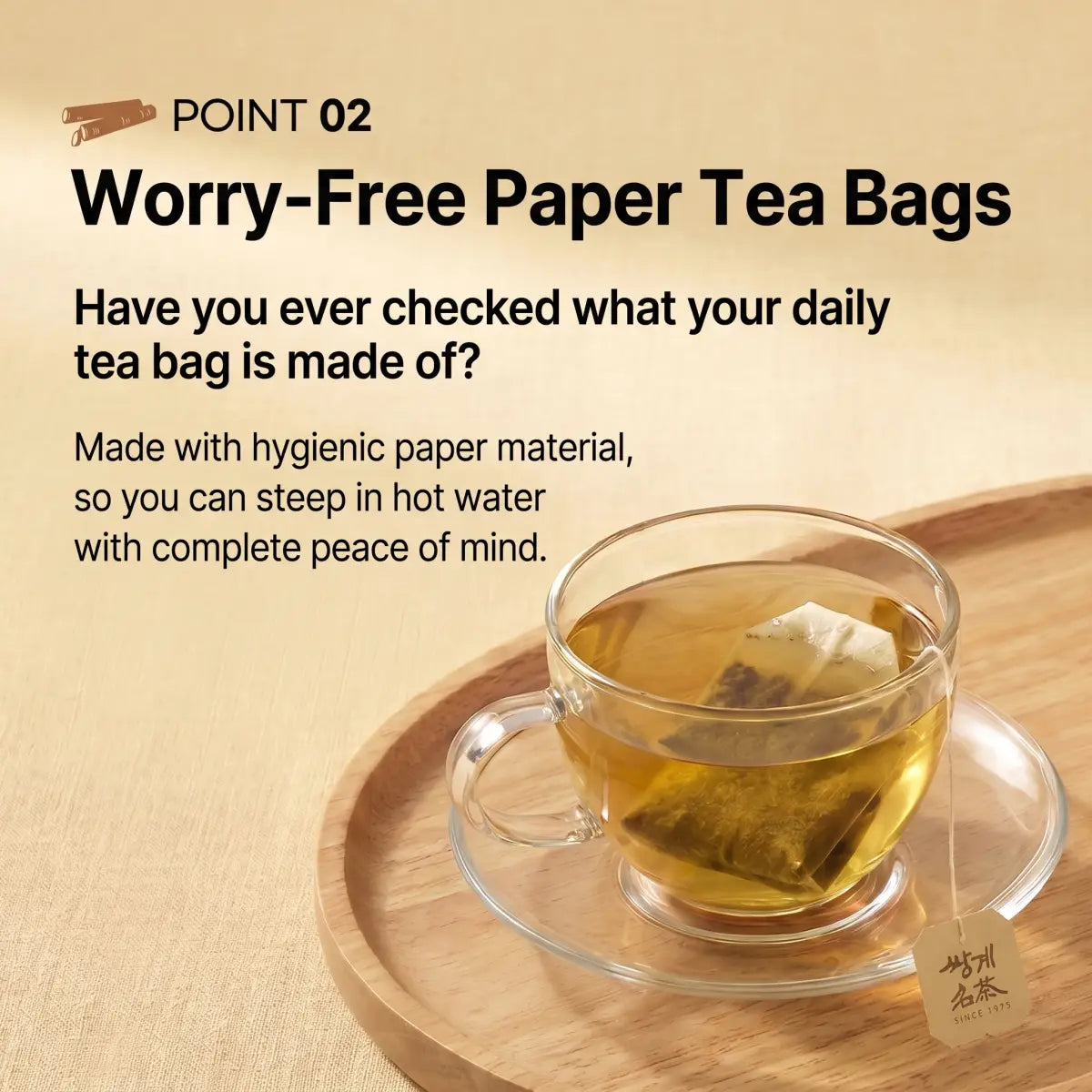 A clear glass teacup and saucer filled with tea and a paper tea bag, placed on a round wooden tray against a warm beige background. Text on the left reads 'Worry-Free Paper Tea Bags' with promotional copy about hygienic paper material.