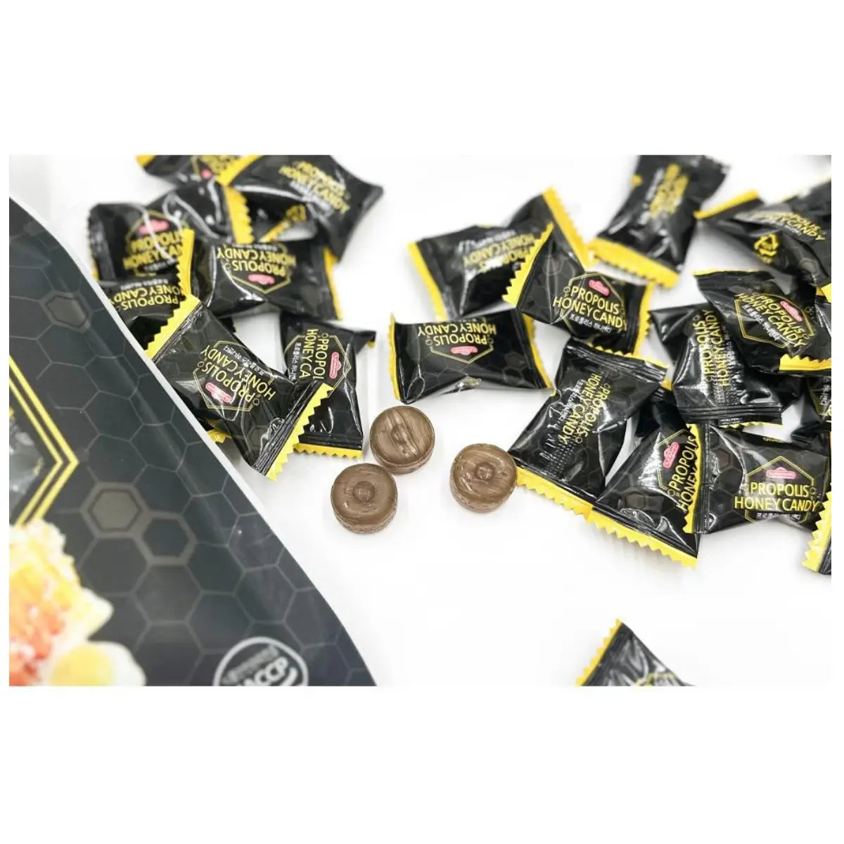 Honeycomb candy with black and yellow packaging on a white background