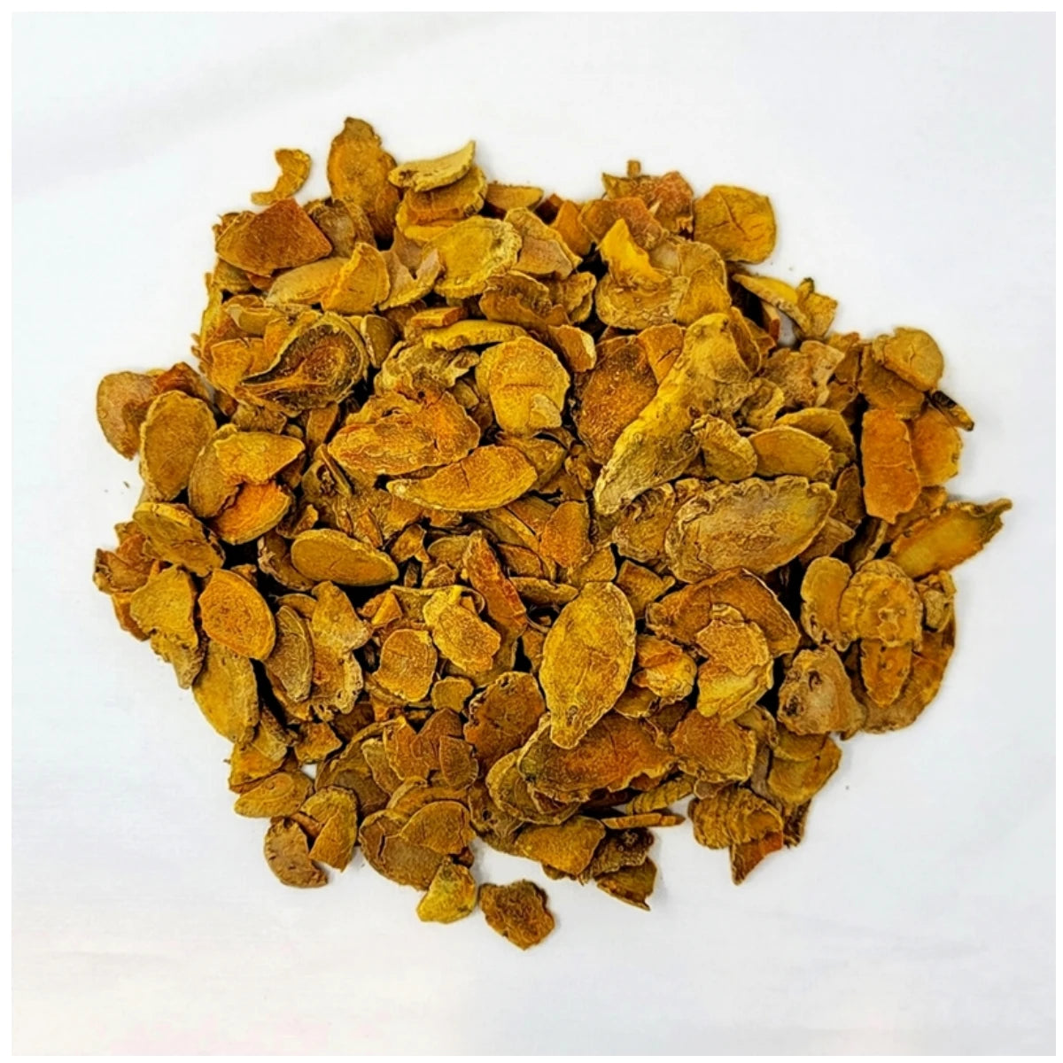 High-quality sun-dried turmeric root slices, showcasing the vibrant orange interior and earthy texture of raw Indian turmeric for herbal tea.