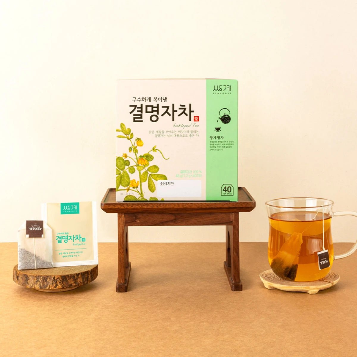A box of Ssanggye Cassia Seed Tea on a modern desk setup to soothe screen fatigue during work.