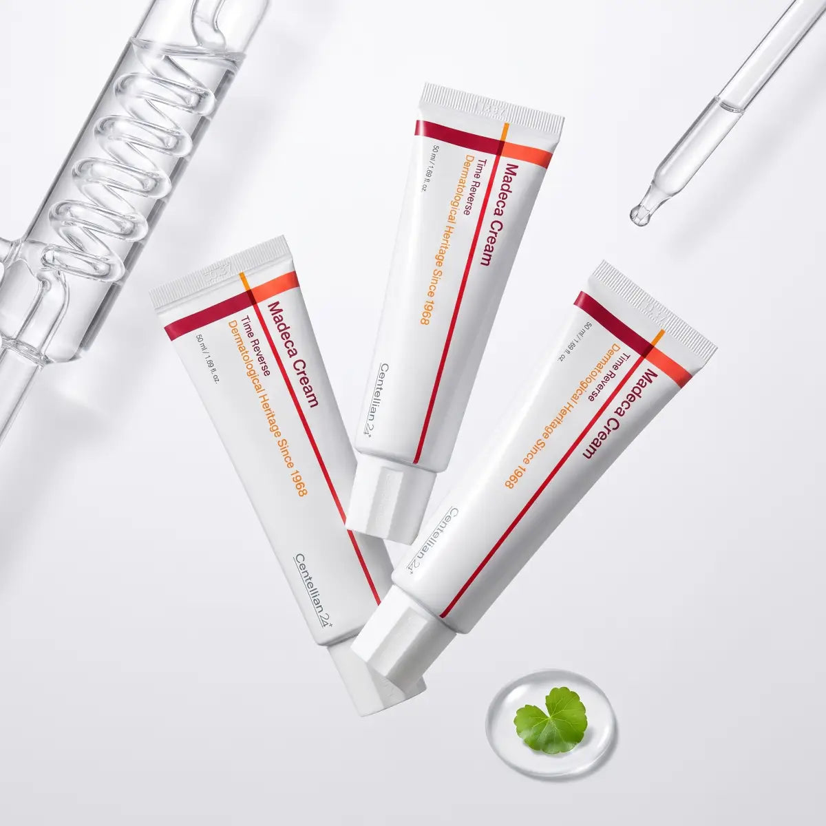 Three Centellian24 Madeca Cream Time Reverse tubes beside a glass ampoule dropper