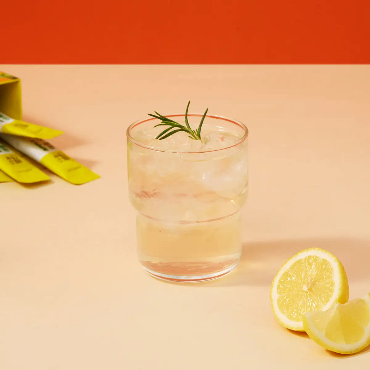 Danongwon apple cider vinegar lemon tea sticks in a glass, showcasing a refreshing citrus beverage with lemon slices and tea.