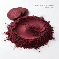 A pile of vibrant dark red Herb & Honey Beet Root Powder 8oz with fresh sliced beet roots on a white background, highlighting the natural superfood texture.