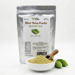Herb & Honey 100% Pure Korean Bitter Melon Powder 5.25oz pouch with a bowl of green powder, a wooden scoop, and fresh bitter melon fruits on a white background.