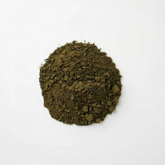 Close-up of a pile of fine, dark green 100% pure Brazilian Graviola Soursop leaf powder by Herb & Honey on a white background.