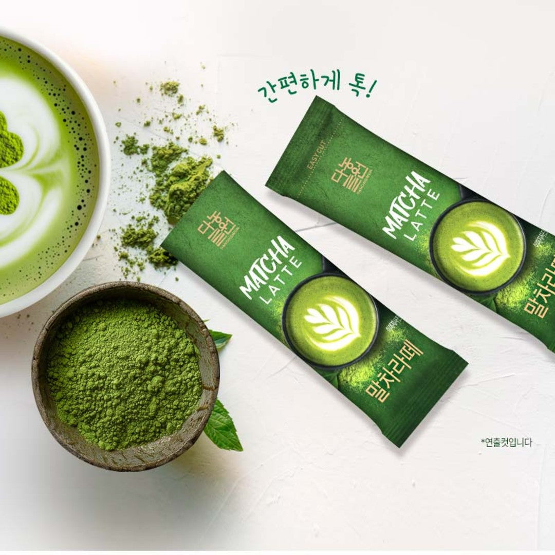 Korean matcha latte mix sticks with a bowl of green tea powder and a matcha latte