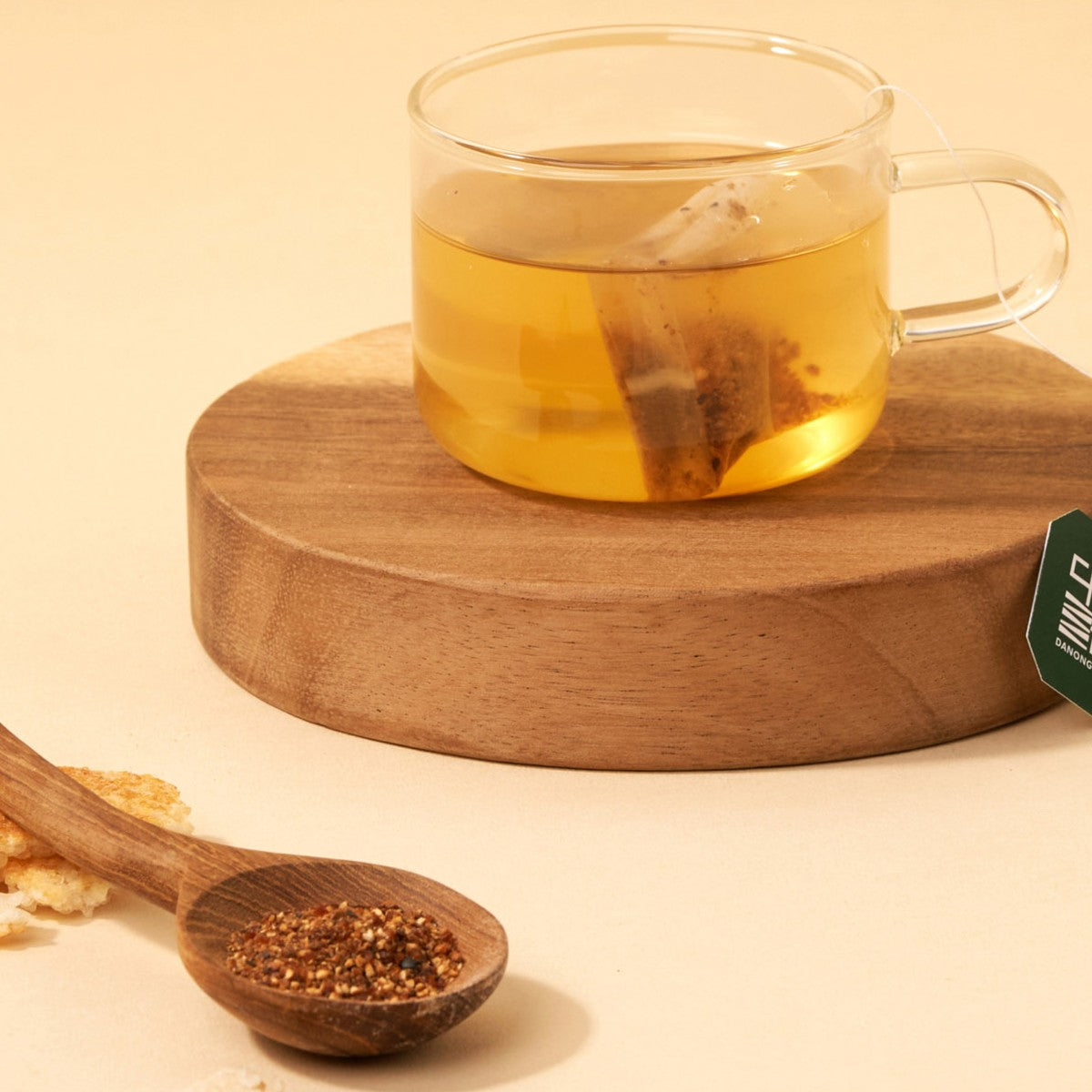 Korean nurungji Solomon's seal tea in a glass cup on a wooden coaster with scorched rice
