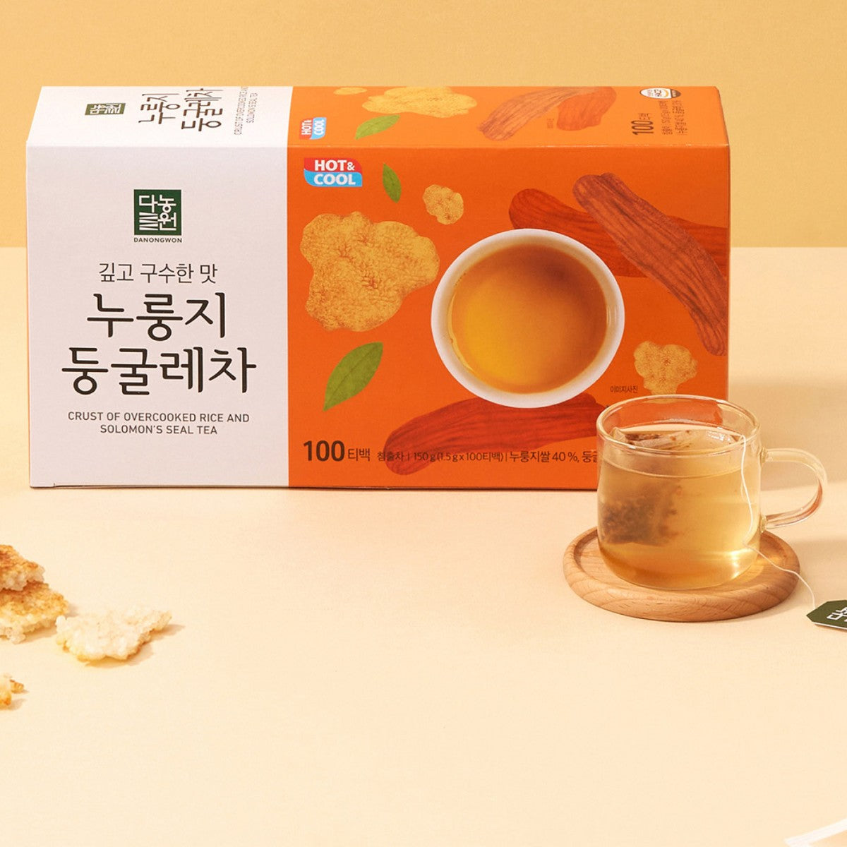 Danongwon nurungji Solomon's seal tea box beside a glass cup of tea and pieces of scorched rice
