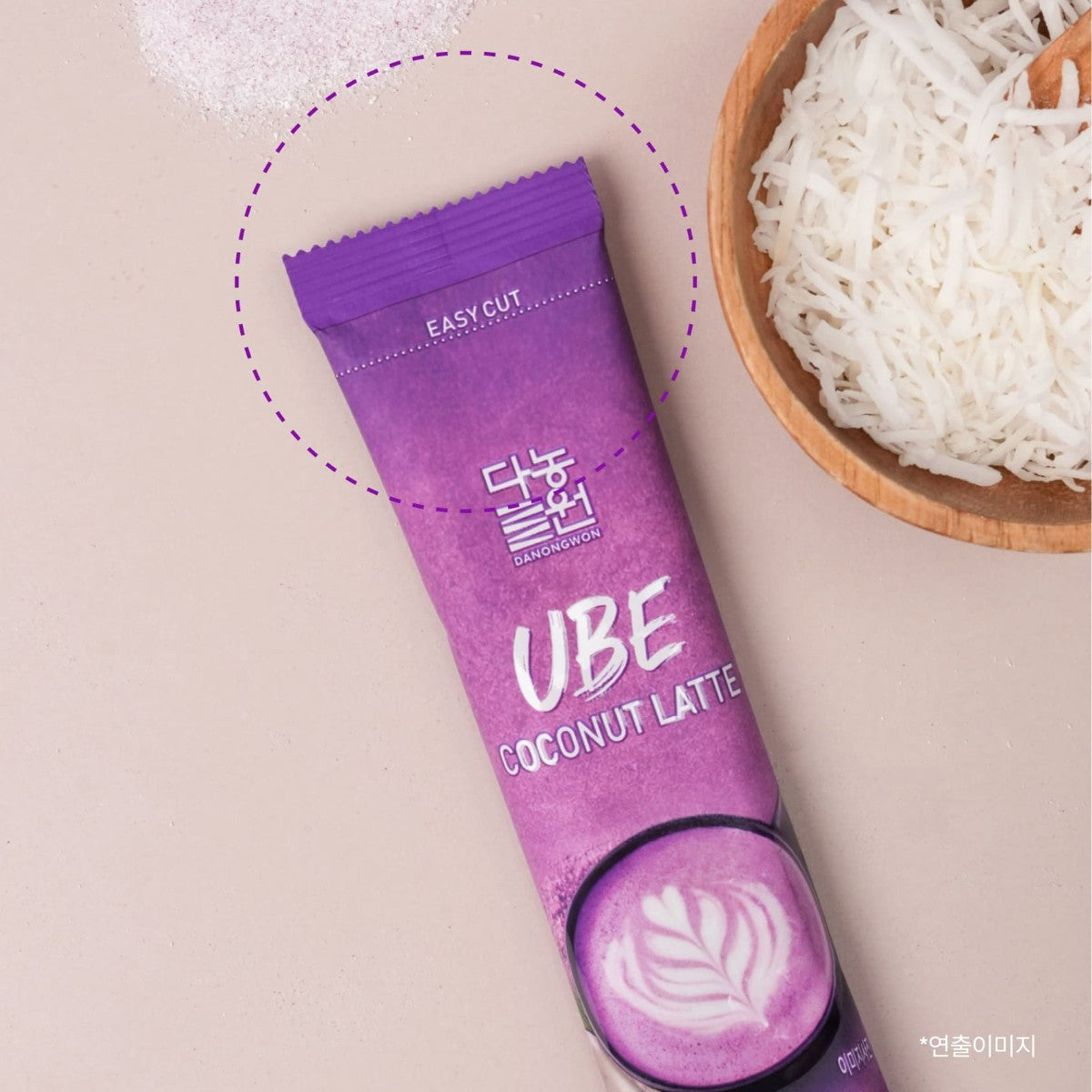 Single Korean ube coconut latte stick next to a bowl of shredded coconut