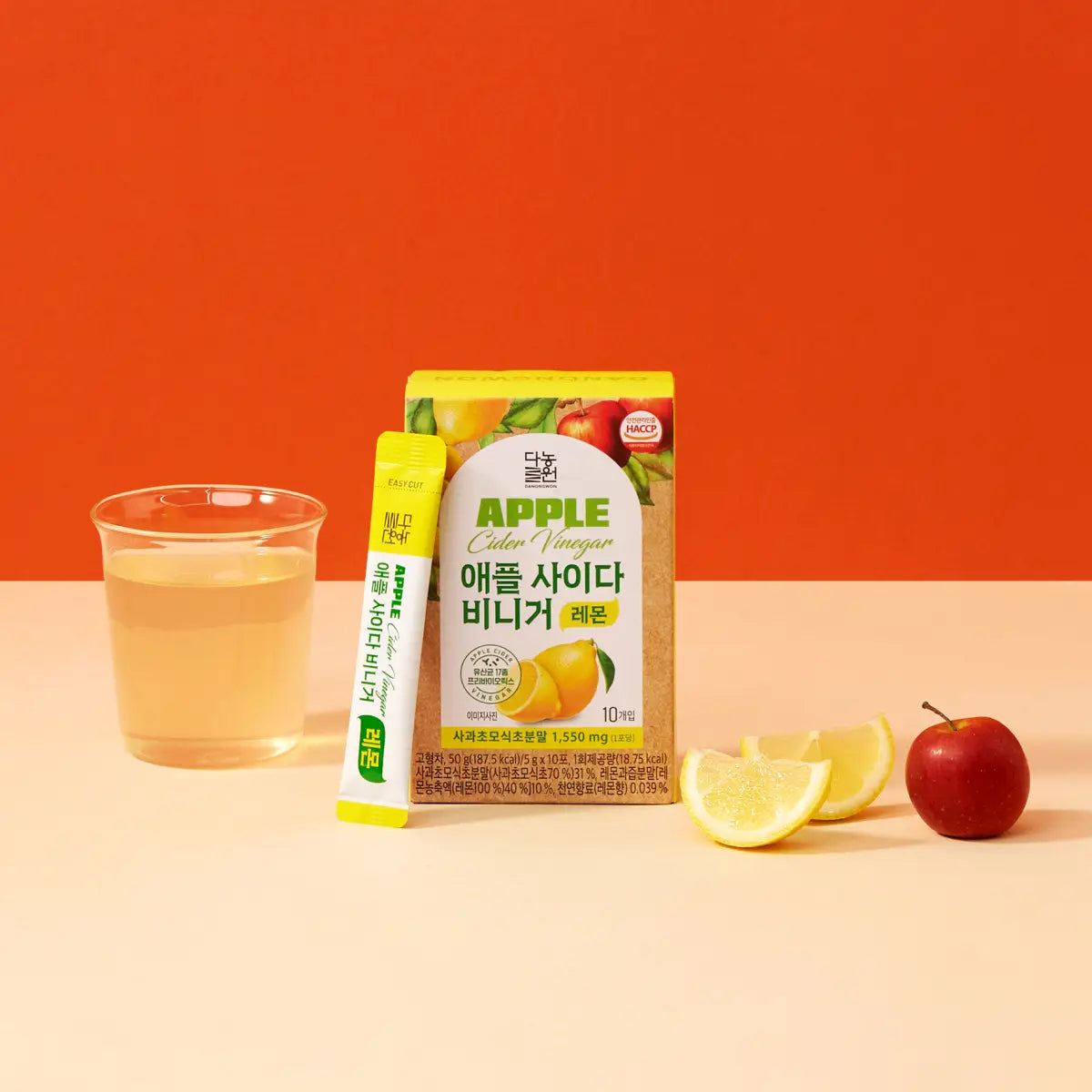 Danongwon Apple Cider Vinegar Lemon Drink Mix tea in a clear glass with ice, showing the refreshing lemon-flavored beverage.