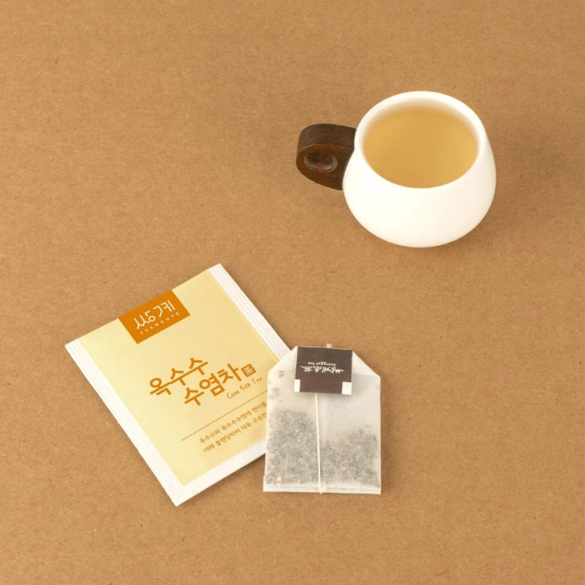Top view of golden Roasted Corn Silk Tea in a cup, highlighting its deeply savory and naturally nutty flavor profile .